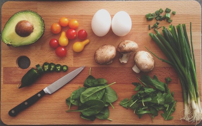 Simple bowl with fresh fruit and nuts on a clean table